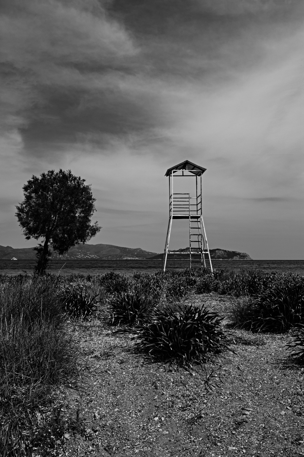 An old lifeguard post on a deserted beach on a Greek island taken in black and white