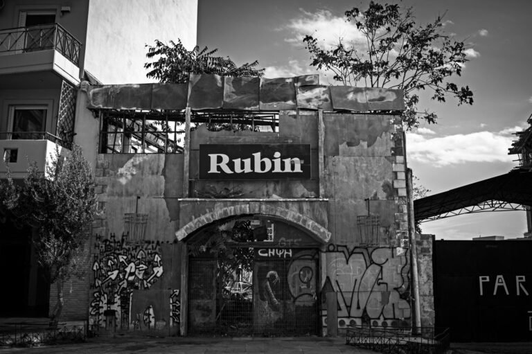 The façade of an old abandoned nightclub taken in black and white