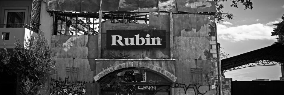 The façade of an old abandoned nightclub taken in black and white