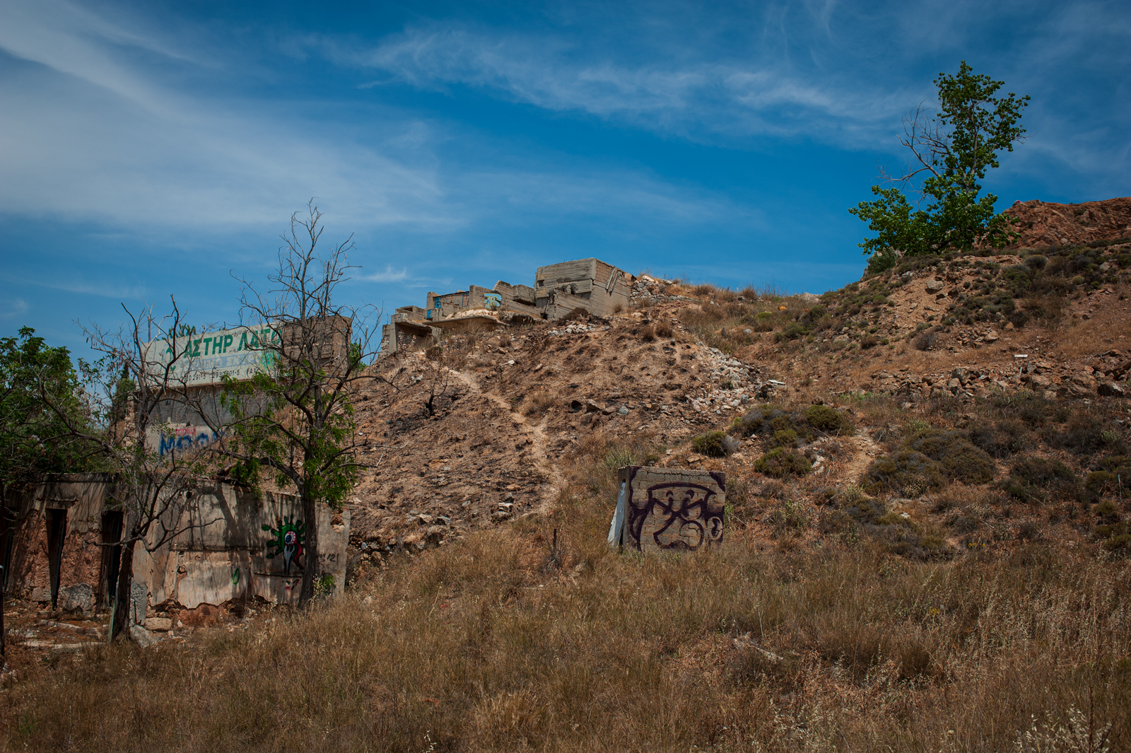 A photograph taken on the way up the mountain in Athens with an abandoned factory in the background.