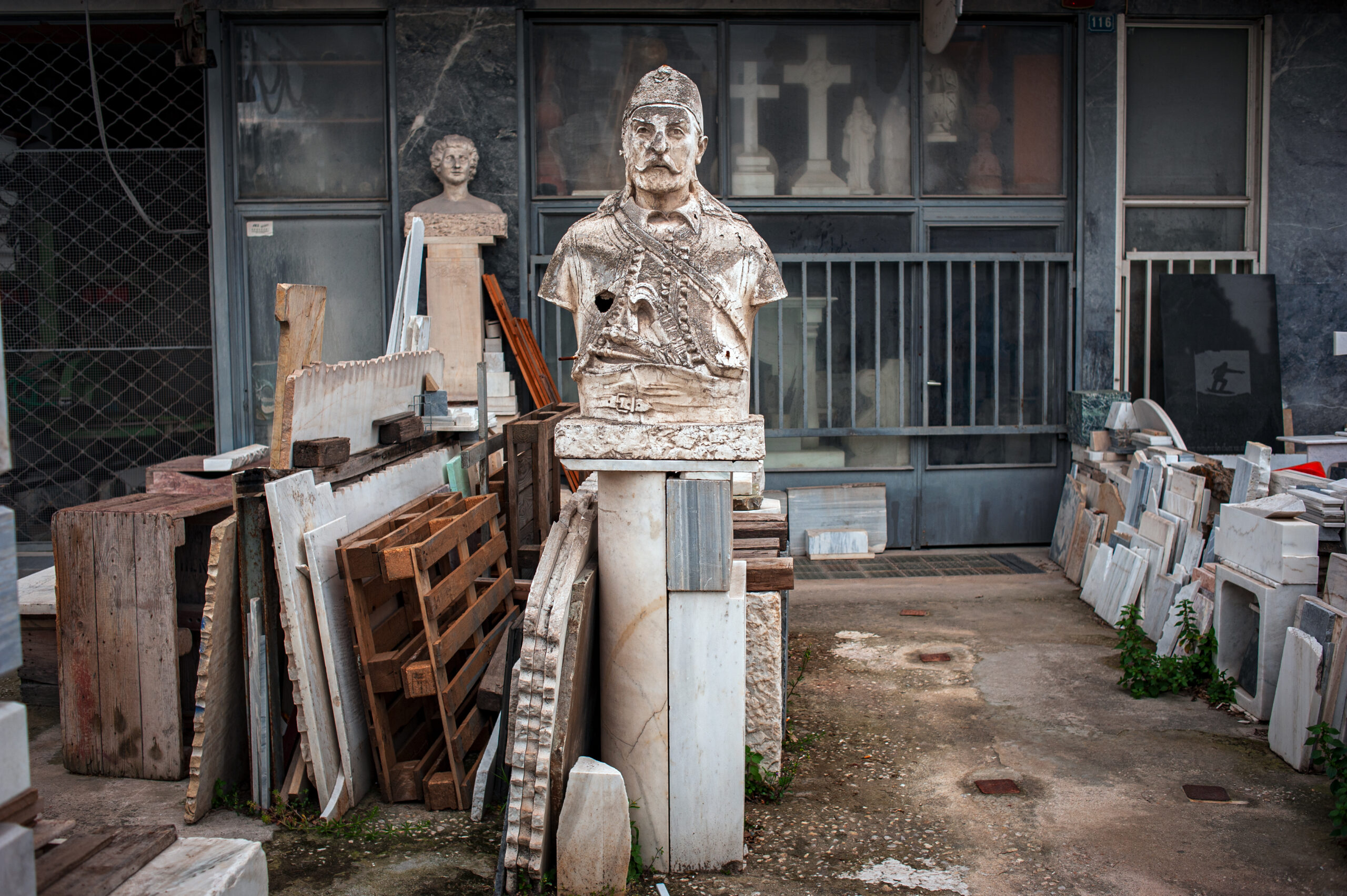 A photograph of an abandoned marble workshop that used to make grave stones and marble sculptures.
