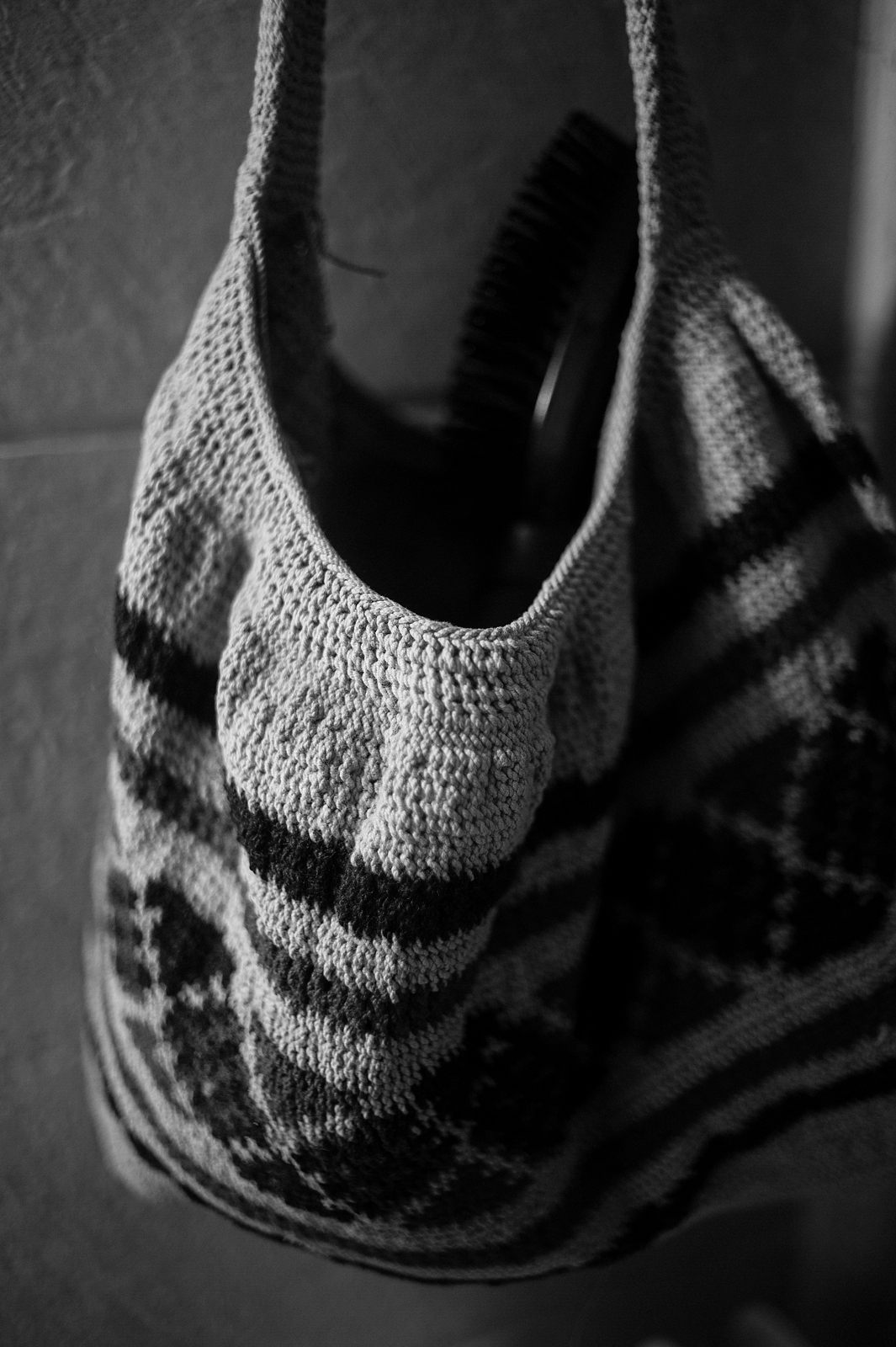 Closeup black and white photograph of a detail of woven bag