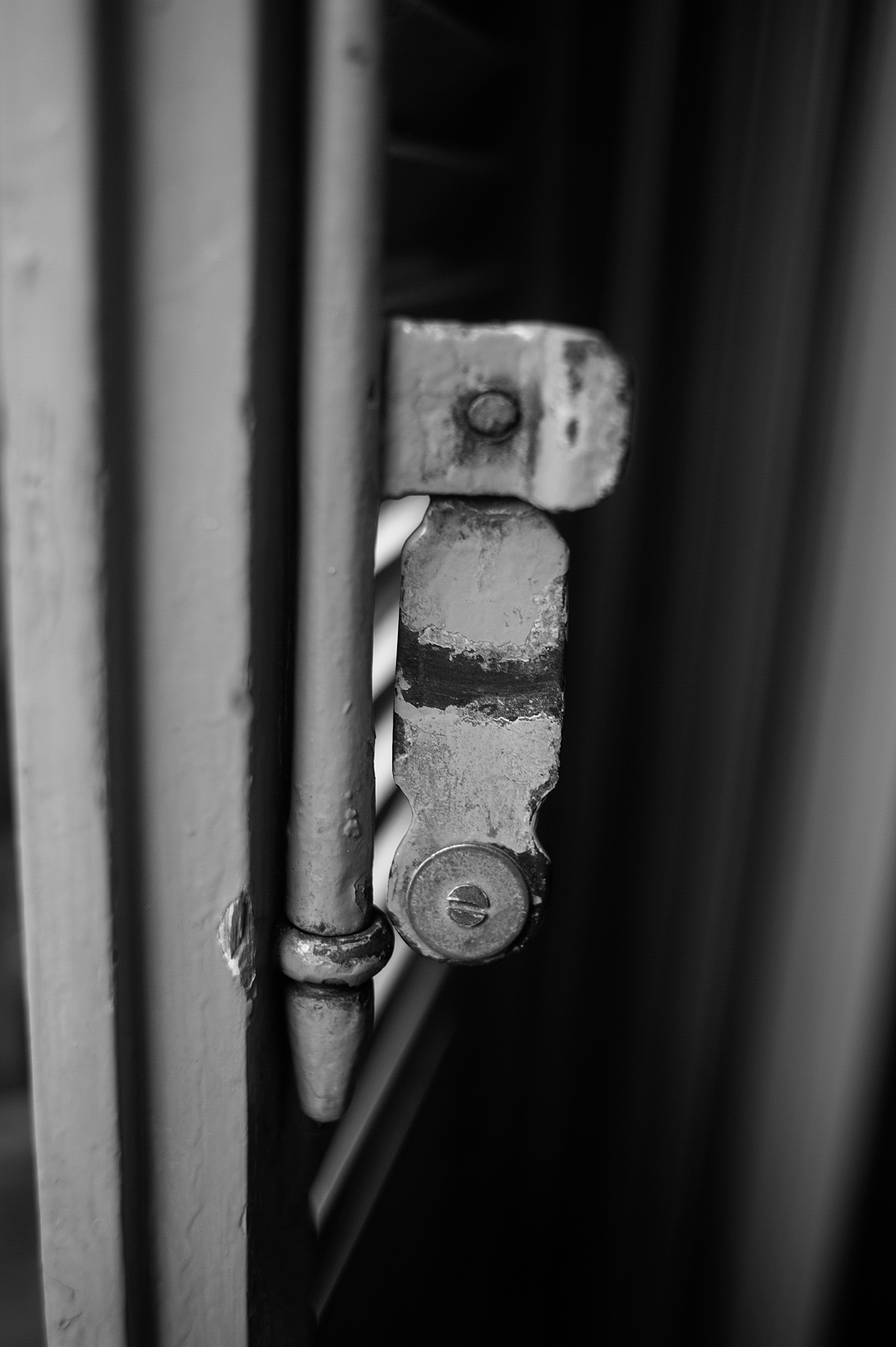 Closeup black and white photograph of a detail of shutter latch
