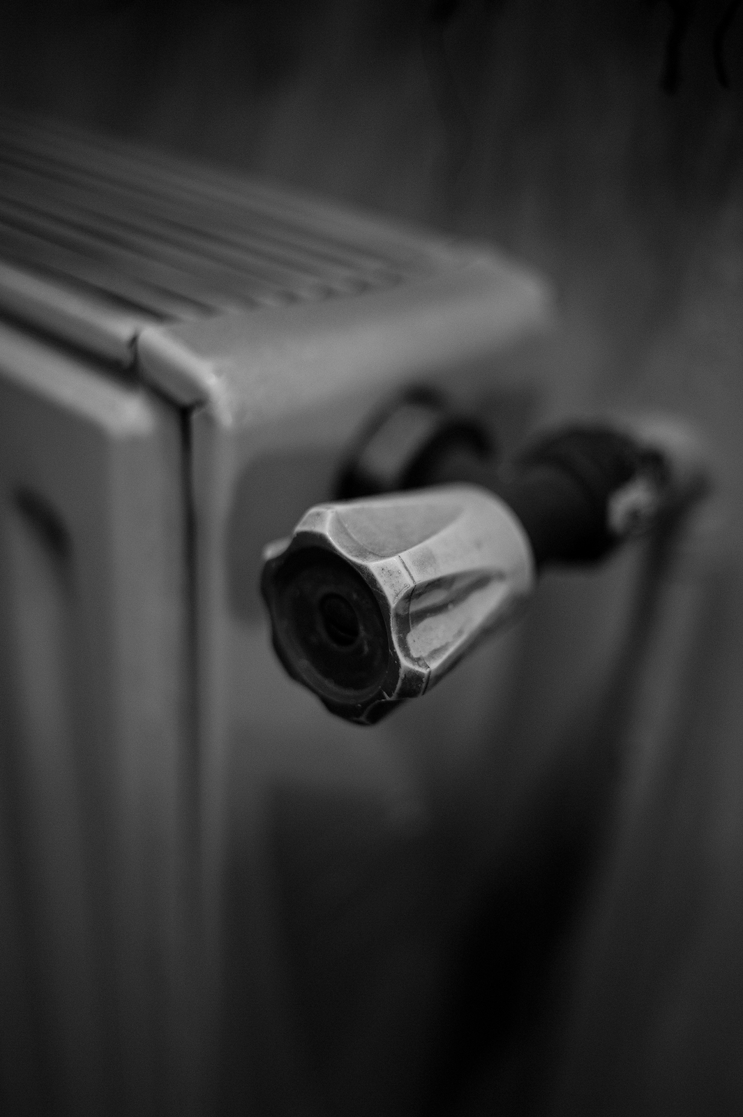 Closeup black and white photograph of a detail of an old radiator.