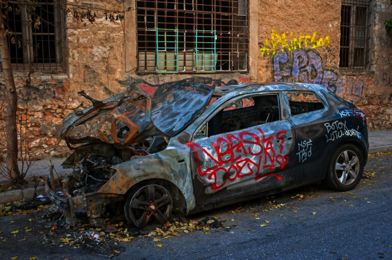 A burned out car on the streets of Athens.