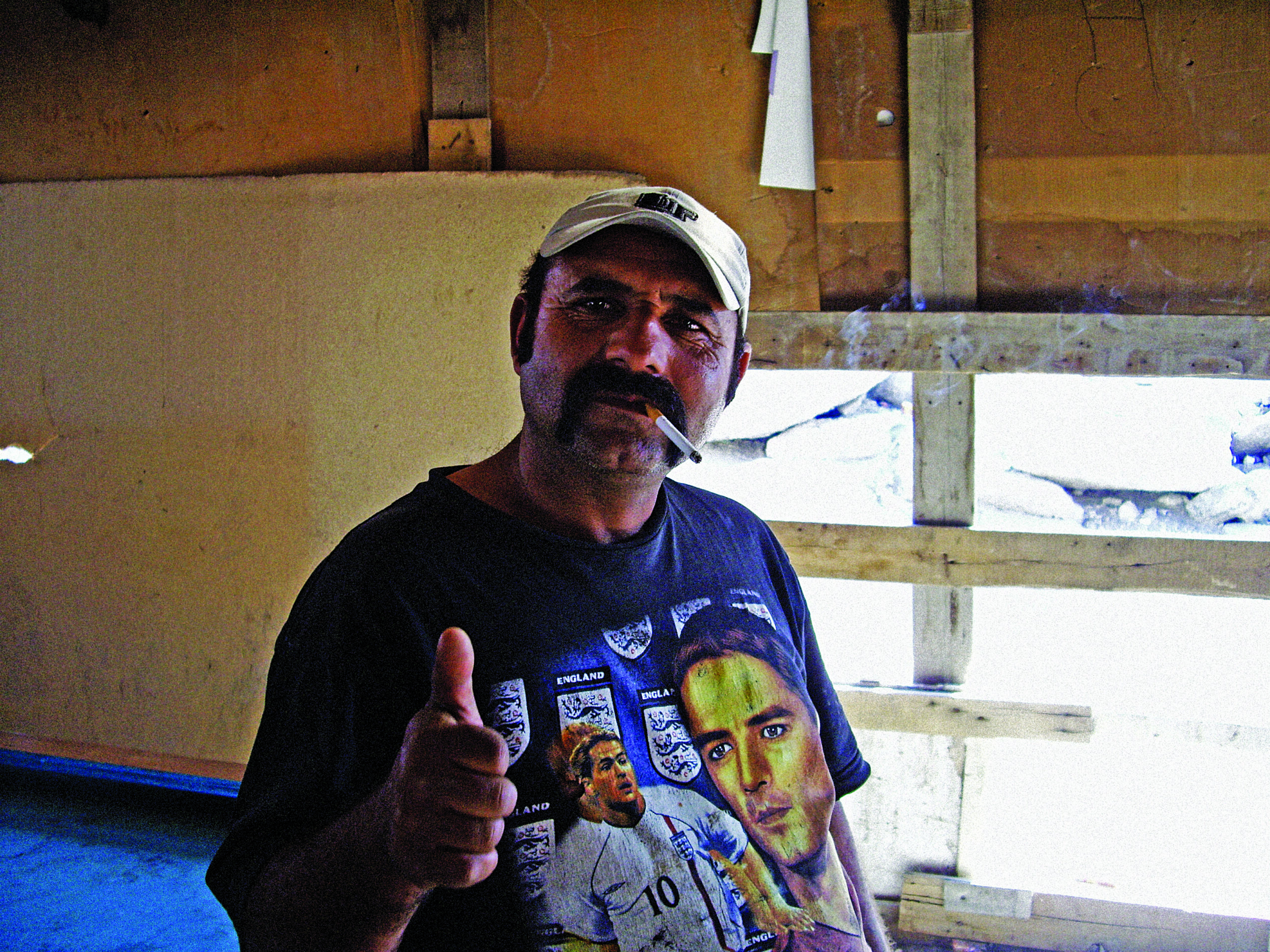 Man at a Roma camp in Athens.