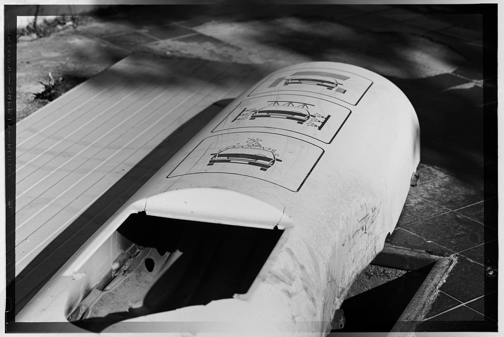 A photograph of an abandoned garage sign in black and white